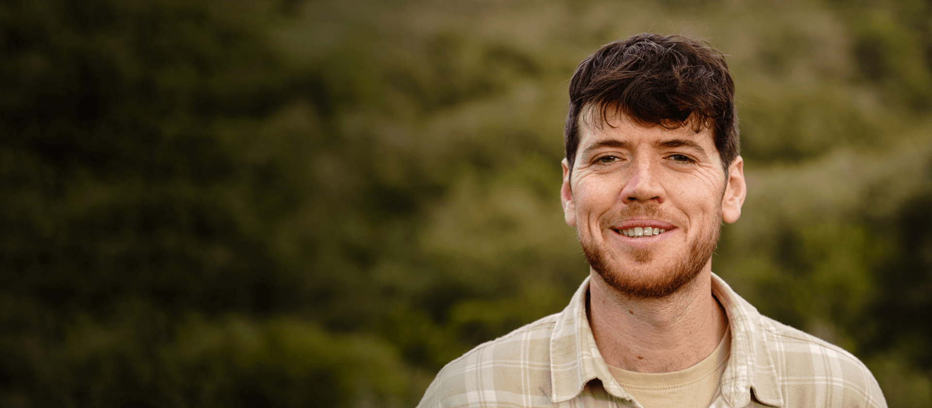 Workforce Ausralia participant looks happily at the camera, while standing outside