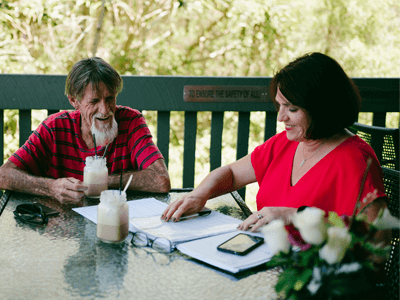 Disability employment services consultant meting with her mature aged customer at a local cafe