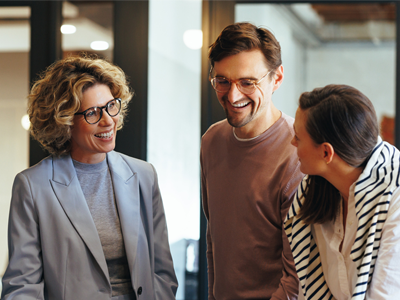 Three team members chatting in the office